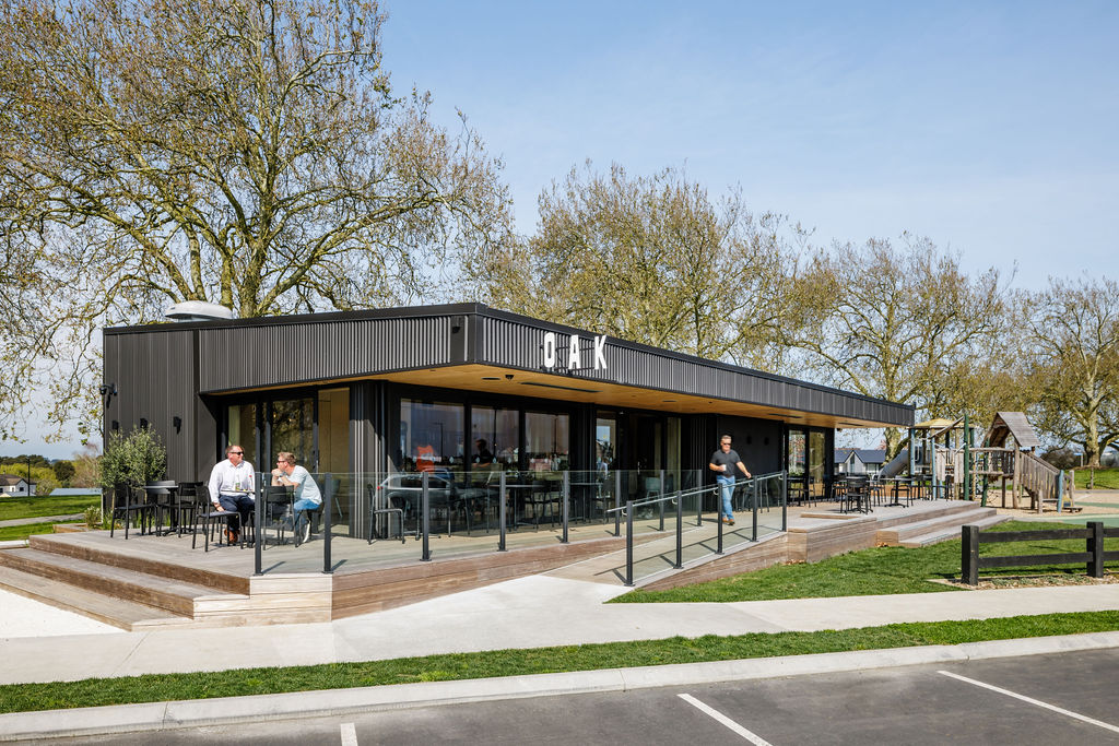 Lockerbie Cafe in Morrinsville — dark metal cladding, timber deck and glazed frontage, photographed by Aaron Radford