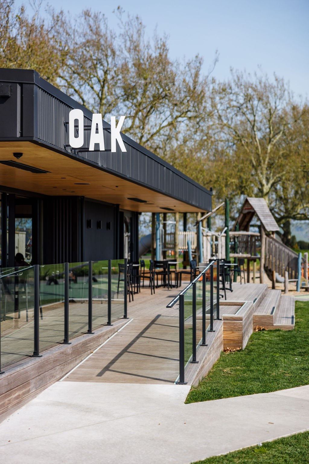 Lockerbie Cafe in Morrinsville — dark metal cladding, timber deck and glazed frontage, photographed by Aaron Radford — view 4